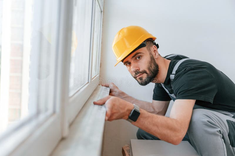 Installazione di un davanzale. l'uomo sta riparando nell'appartamento immagini stock libere da diritti