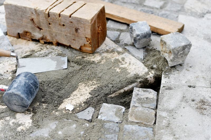 Detail with instalation works of cobblestone pavement. Bricklayer tiler stock images, royalty-free photos and pictures