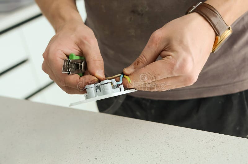 Installing an Electrical Outlet on a Kitchen Countertop, Closeup Stock