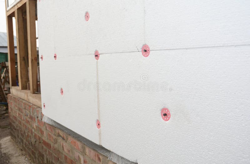 Installing Foam Insulation Board with Plastic Nails for House Energy Saving. House Foam