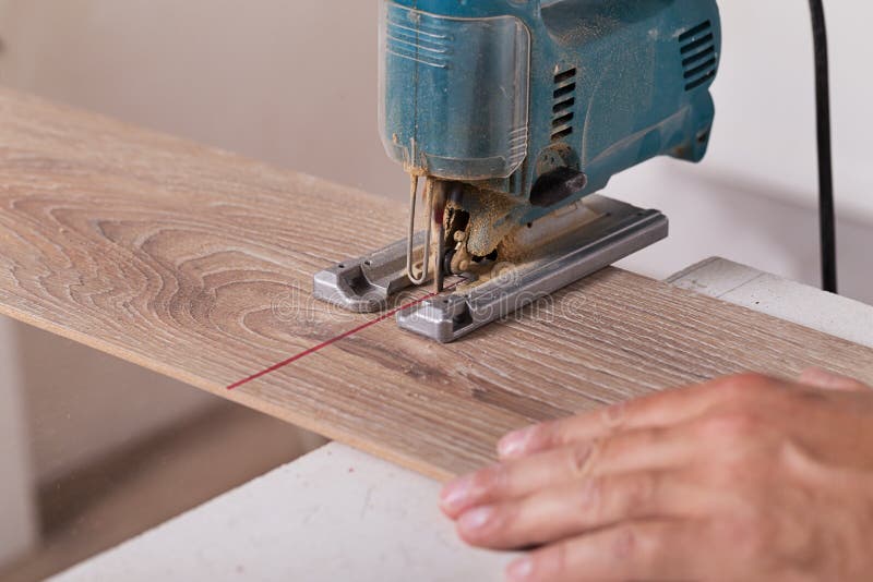 Installing Laminate Flooring. Carpenter Cut Parquet Floor Board Stock