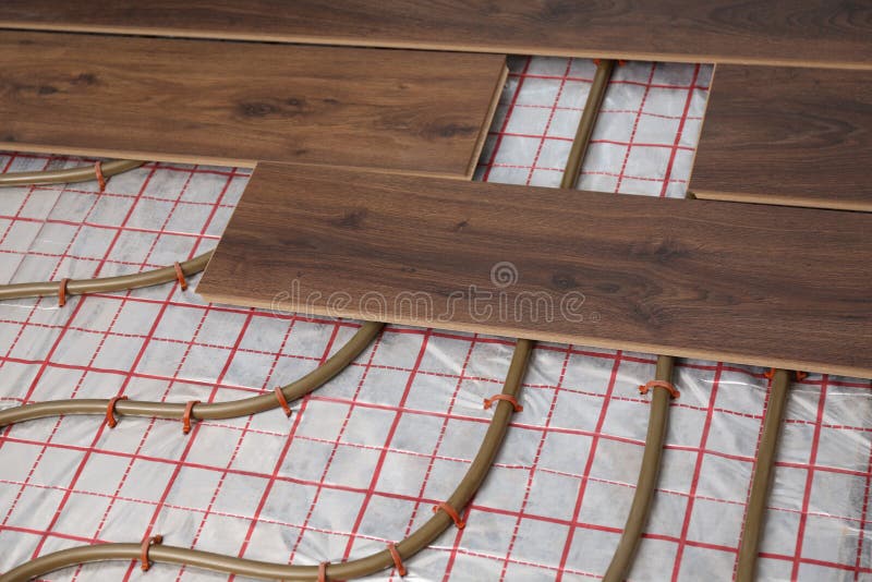 Installing New Wooden Laminate Over Underfloor Heating System Stock