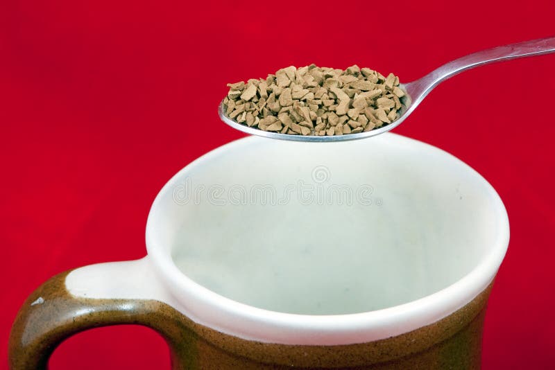 Close-up of silver spoon with instant coffee