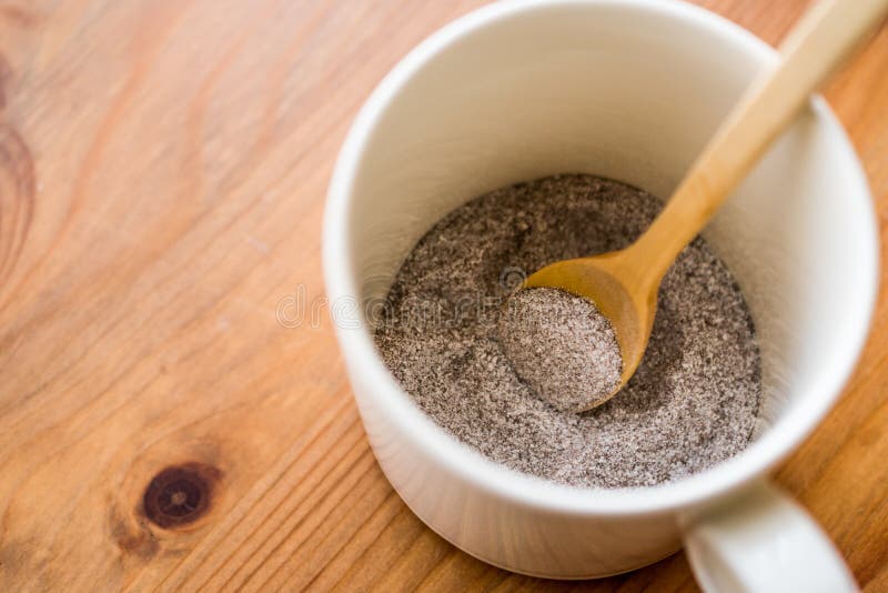 Instant coffee powder 3 in 1; mixed with milk powder and sugar in a cup.