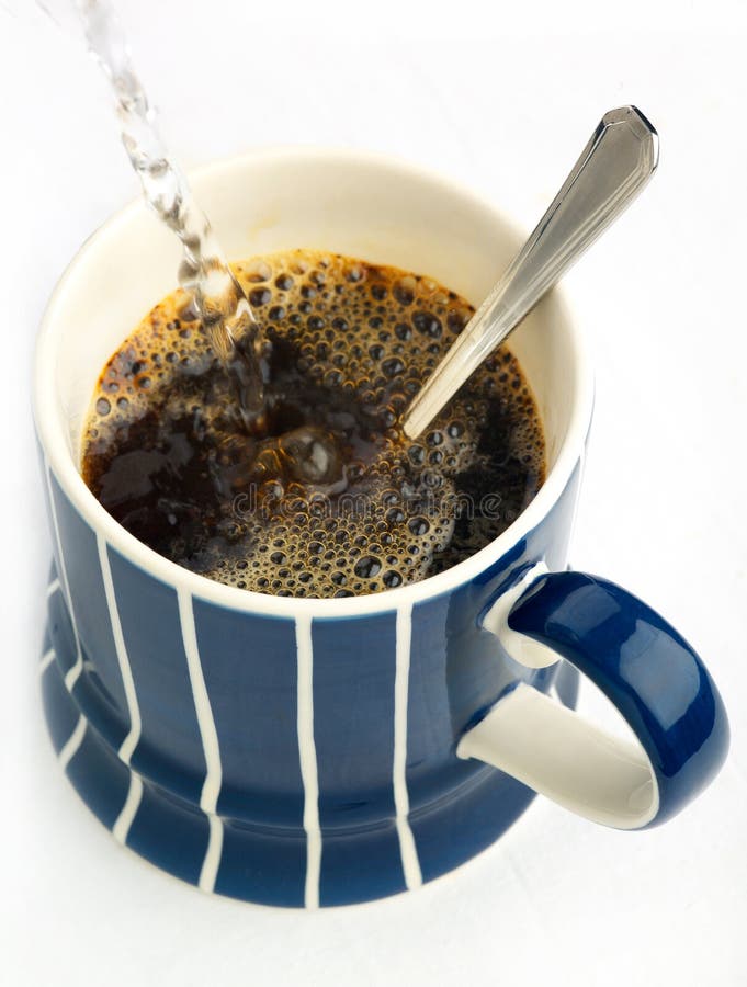 A steaming mug of instant coffee, with hot water being poured. A steaming mug of instant coffee, with hot water being poured.