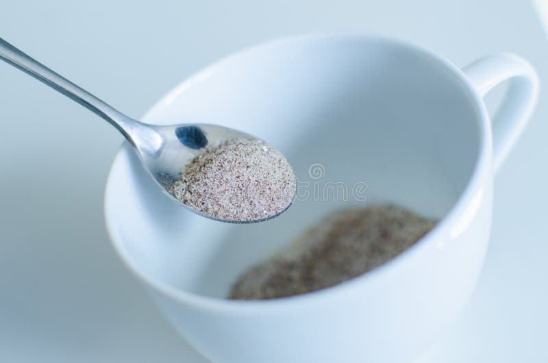 Instant coffee with spoon and white coffee cup