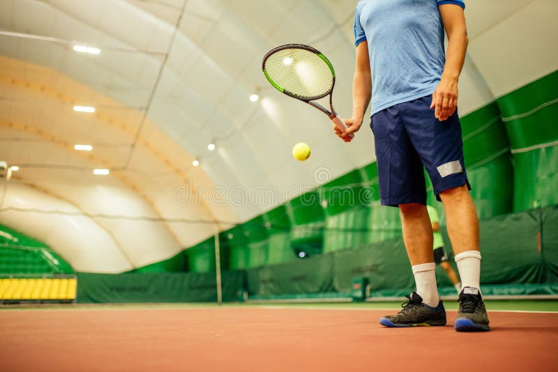 Instructor or Coach Teaching How To Play Tennis on a Court Indoor Stock Instructor or Coach Teaching How To Play Tennis on a Court Indoor Stock