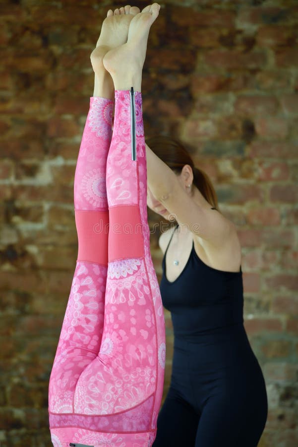 Instructor Helps To Do Yoga Exercise on an Stretching Stock Photo