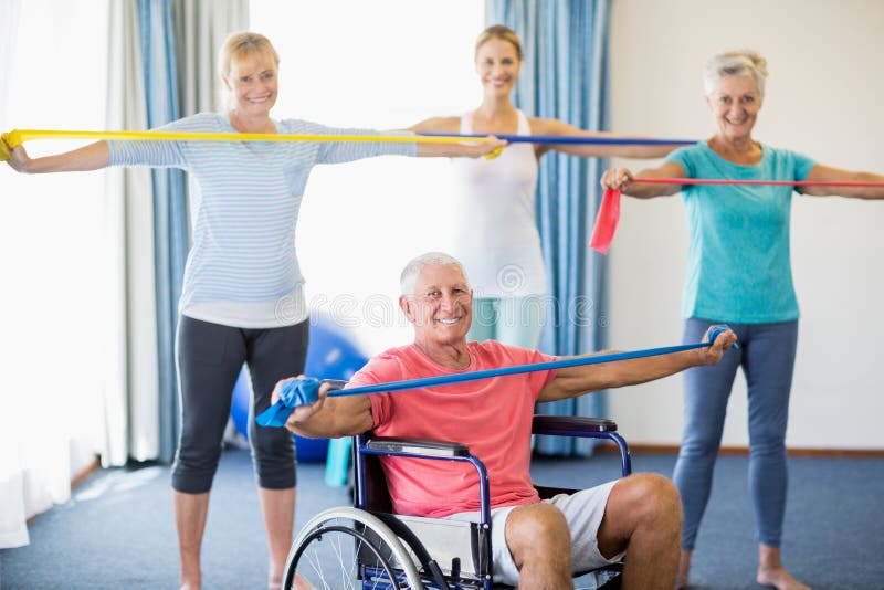 Instructor and seniors exercising with stretching bands stock image Instructor and seniors exercising with stretching bands stock image