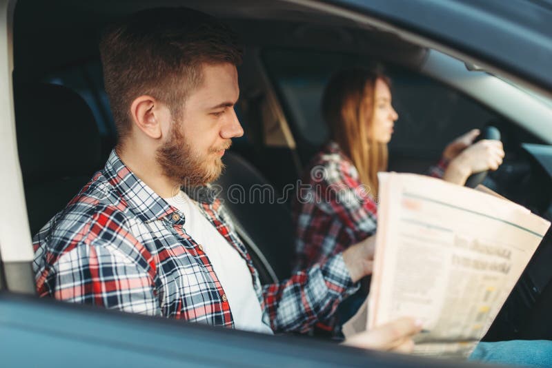 Instructor taking the exam, female student drives royalty free stock image Instructor taking the exam, female student drives royalty free stock image