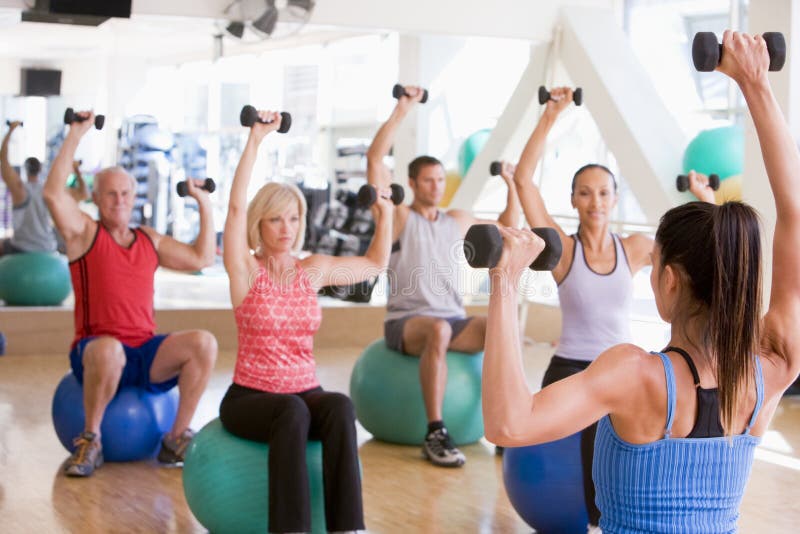 Instructor Taking Exercise Class At Gym Royalty Free Stock Image