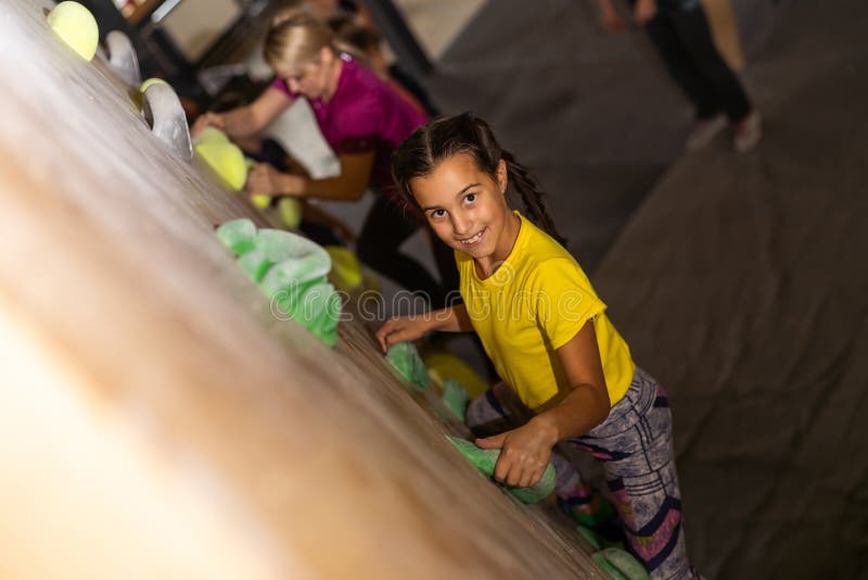 Instructors Helping Children Climb Wall In Gym Stock Photo Image Of