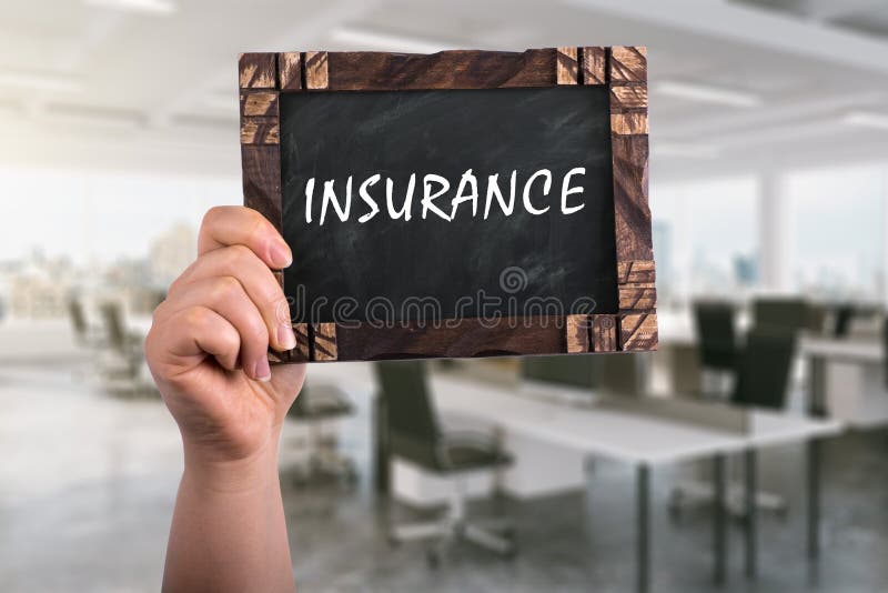 A woman holding wooden blackboard with text insurance ,office background. A woman holding wooden blackboard with text insurance ,office background