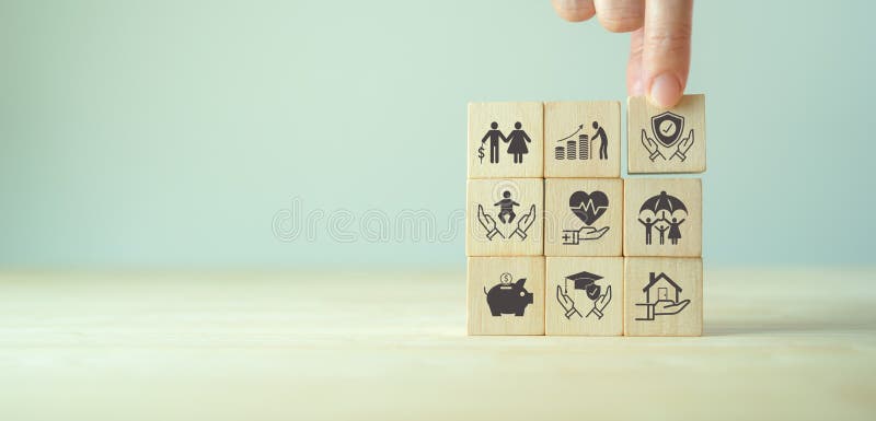 Insurance and Stages of Life Concept. Hand Puts Wooden Cube with