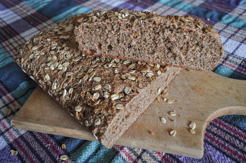 homemade Integral black brown bread on  wood kitchen board