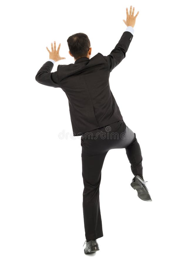 Integral del hombre de negocios joven que sube una pared imagen de archivo Integral del hombre de negocios joven que sube una pared imagen de archivo