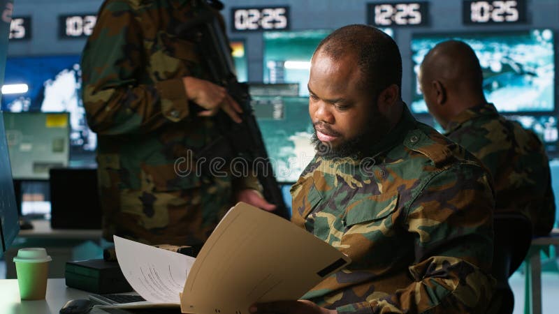 Intelligence specialist reading mission case file stock images