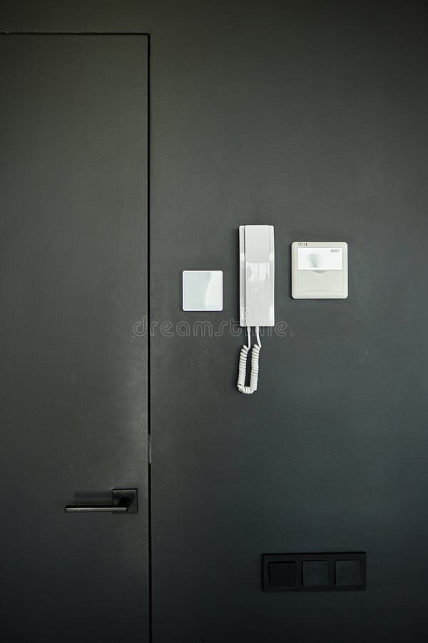 Intercom Handset with Electronic Video Panel Mounted on Black Wall in Apartment stock photo