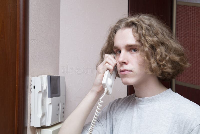 Intercom. A man uses an intercom to communicate with guests stock photos