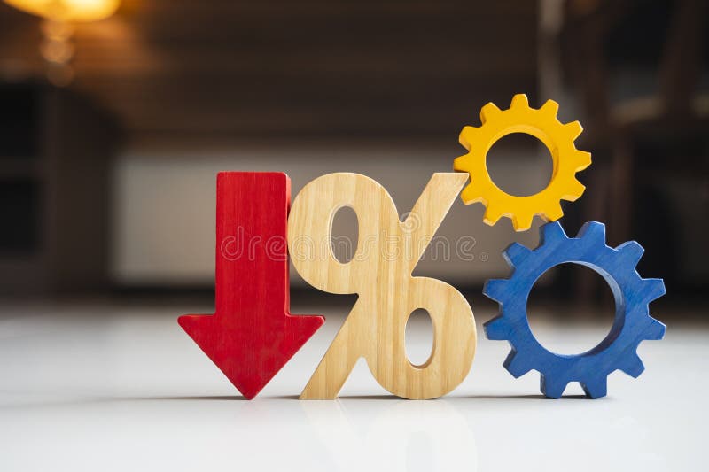 Interest rate cut and percentage decrease concept with red down arrow, wooden percent sign, and gears. Financial loan reduction, mortgage refinance drop, cost discount, and economic deflation policy. Decline loss decrease illustrations