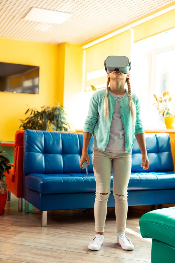 Interested schoolgirl getting acquainted with virtual reality. royalty free stock photo