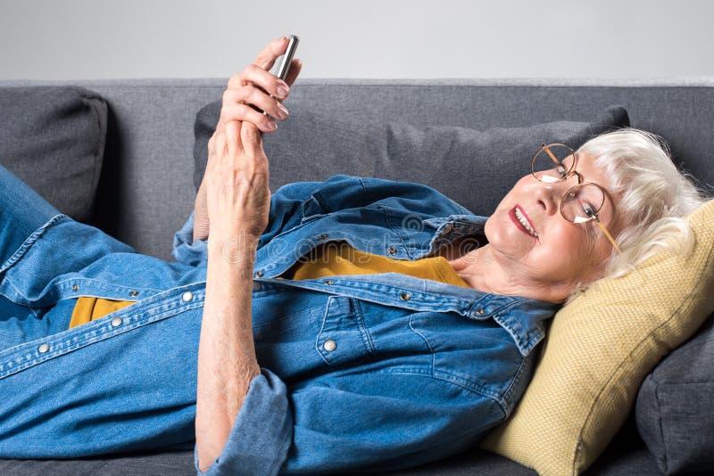 Mature Woman on the Sofa with a Phone Stock Photo - Image of people, modern: 725