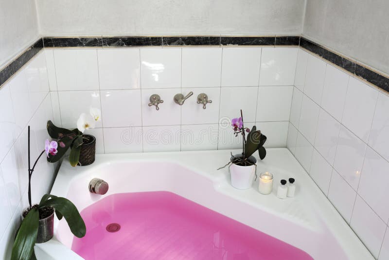 Bathtub with pink water stock image. Image of flower 120786265