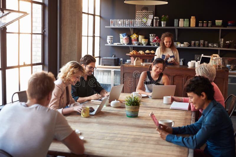 Interior Of Coffee Shop With Customers Using Digital Devices royalty free stock photography Interior Of Coffee Shop With Customers Using Digital Devices royalty free stock photography