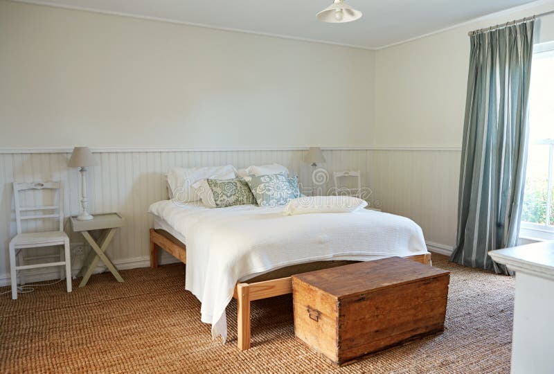 Interior of a comfortable bedroom in a country style home stock image Interior of a comfortable bedroom in a country style home stock image