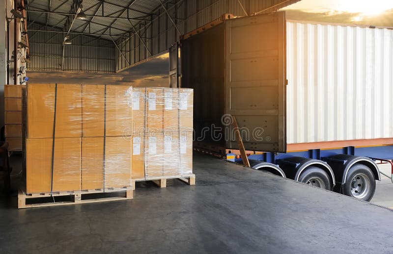 Interior of warehouse dock, Large pallet shipment goods, truck docking load cargo at warehouse, road freight delivery logistics shipping and transport. Interior of warehouse dock, Large pallet shipment goods, truck docking load cargo at warehouse, road freight delivery logistics shipping and transport.