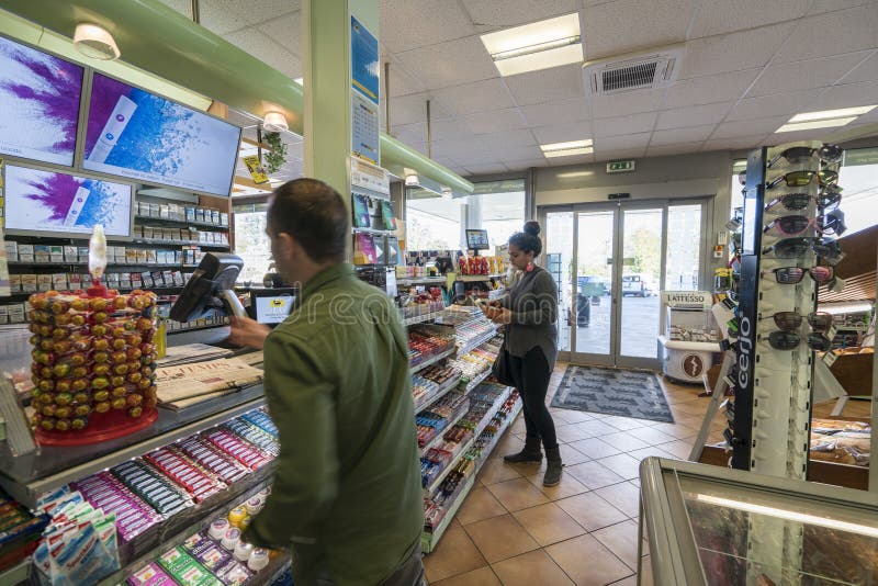 Very high resolution, 42.2 megapixels. Gas station store interior in Geneva, Switzerland. Customers are paying at the cash register inside a gas station shop. Photo taken on: April, 10, 2016. Very high resolution, 42.2 megapixels. Gas station store interior in Geneva, Switzerland. Customers are paying at the cash register inside a gas station shop. Photo taken on: April, 10, 2016.