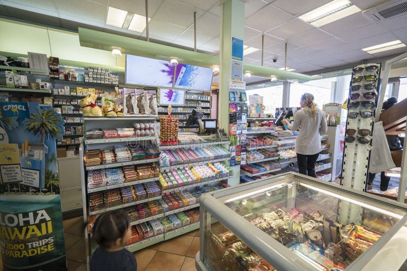 Very high resolution, 42.2 megapixels. Gas station store interior in Geneva, Switzerland. Customers are paying at the cash register inside a gas station shop. Photo taken on: April, 10, 2016. Very high resolution, 42.2 megapixels. Gas station store interior in Geneva, Switzerland. Customers are paying at the cash register inside a gas station shop. Photo taken on: April, 10, 2016.