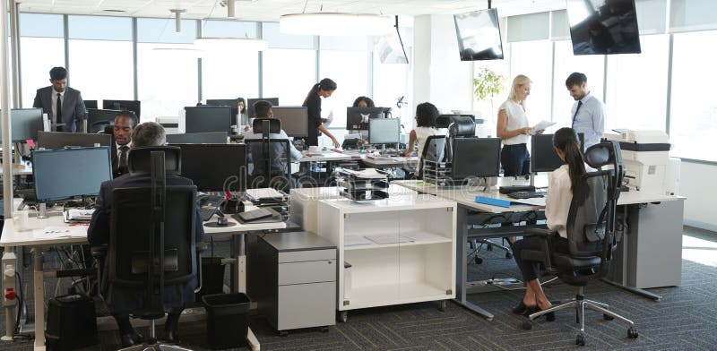 Interior de la oficina abierta moderna ocupada del plan con el personal foto de archivo Interior de la oficina abierta moderna ocupada del plan con el personal foto de archivo