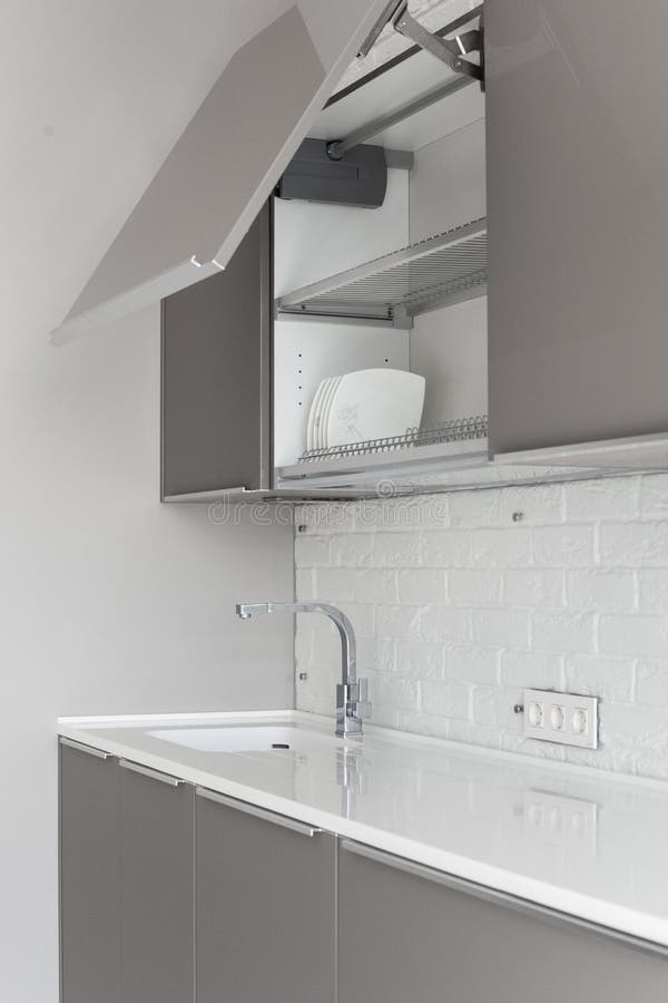 Interior design of clean modern white and black kitchen with stainless steel equipment. royalty free stock images