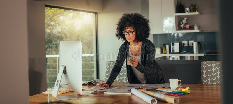 Interior designer with color swatch working on computer stock images