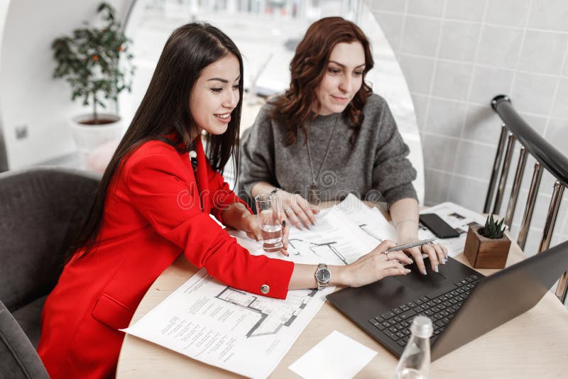 The interior designers the two beautiful girls are working on a new project in a stylish office royalty free stock images The interior designers the two beautiful girls are working on a new project in a stylish office royalty free stock images