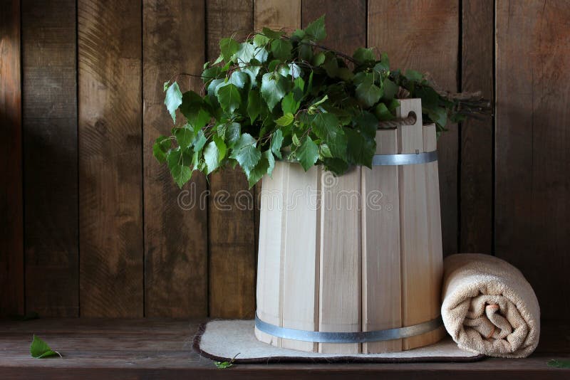 Interior details sauna, steam room with traditional sauna accessories: basin, birch broom, twisted towel