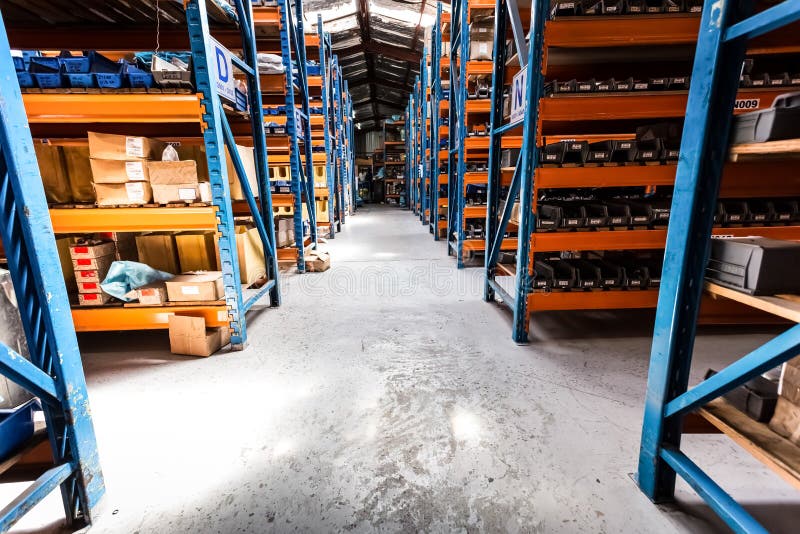 Interior of empty industrial parts distribution warehouse shelves