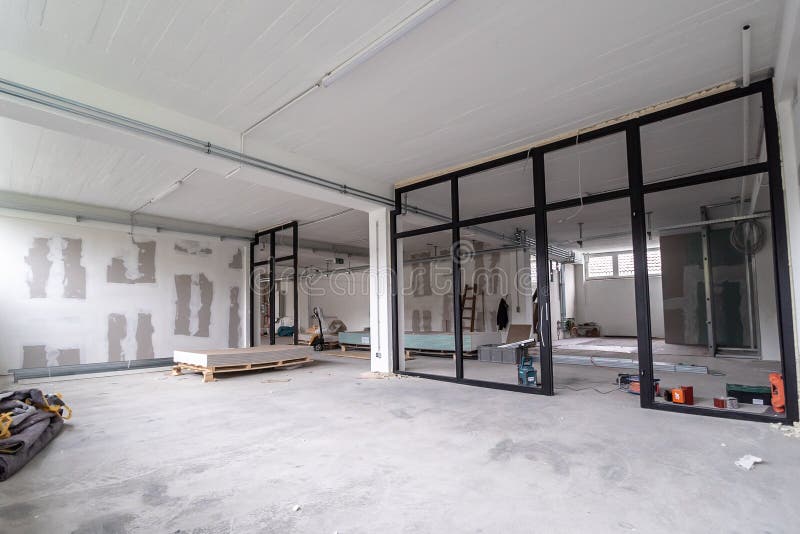 Interior empty office light room in a new building renovation or under construction. Glass doors and Windows