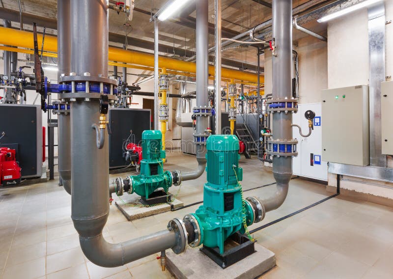 Interior of industrial, gas boiler room with boilers; pumps; sensors and a variety of pipelines stock image