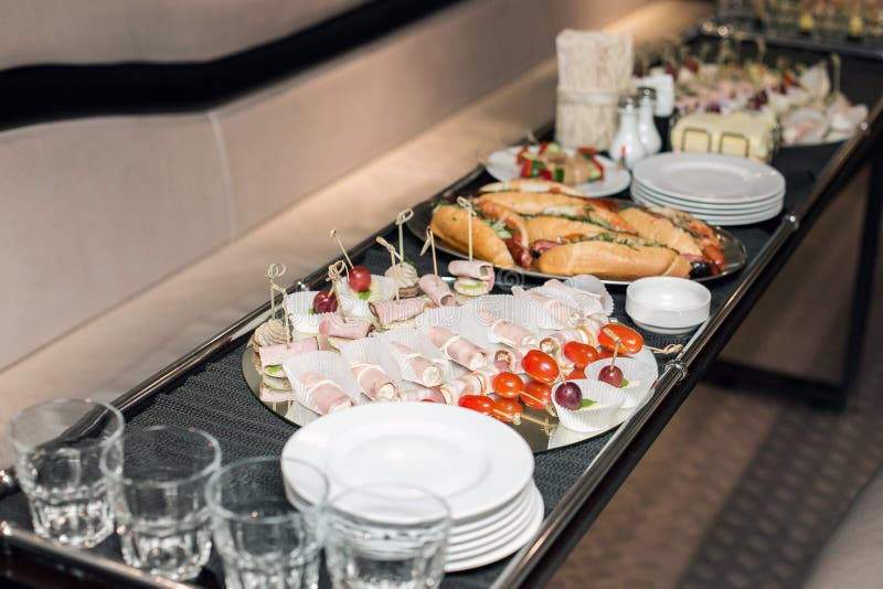 Interior inside the limousine. with sofas and a table covered with snacks for the holiday. Selective focus royalty free stock photography Interior inside the limousine. with sofas and a table covered with snacks for the holiday. Selective focus royalty free stock photography