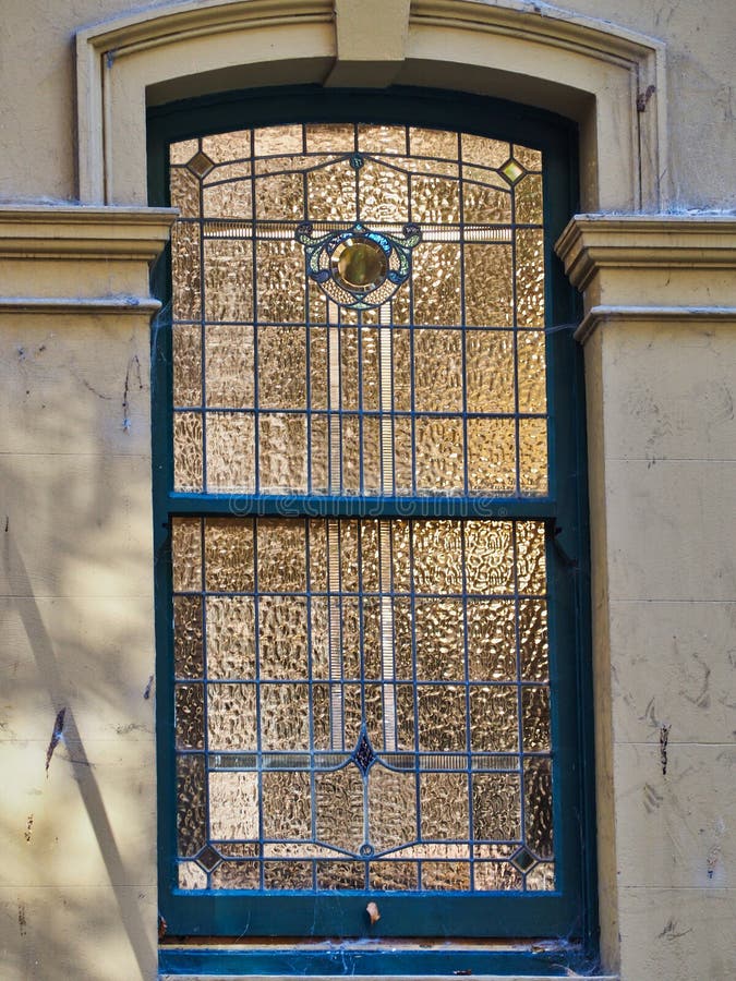 Interior Light Showing Through Historic Rippled Glass Window, Sydney, Australia. Exterior architectural detail of an early 20th century historic Sydney City