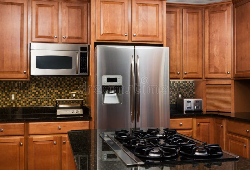 Modern kitchen interior with fitted oven, microwave and refrigerator. Stock  Photo