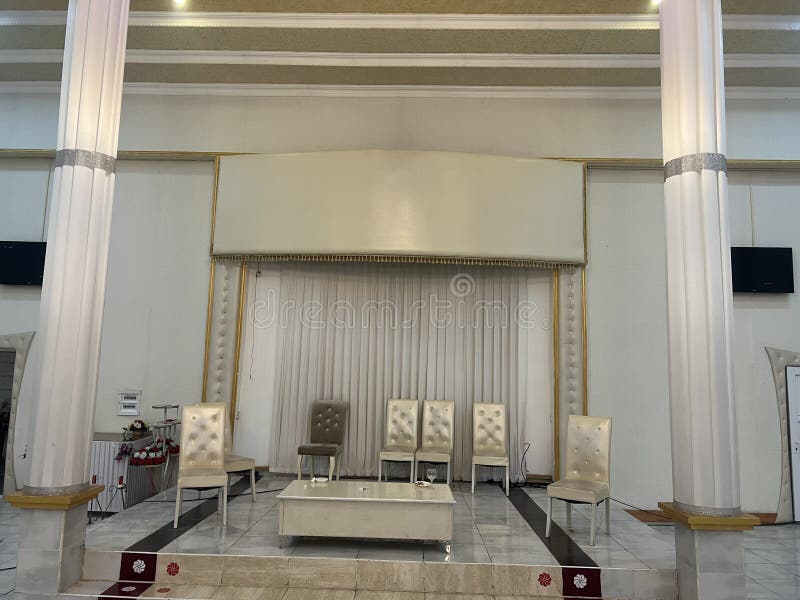 Interior of a Modern Conference Hall with Chairs and a Stage Stock