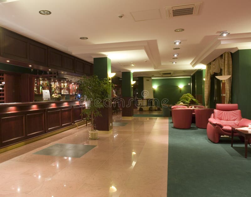 View of a spacious, modern hotel lobby with registration desk and lounge area. View of a spacious, modern hotel lobby with registration desk and lounge area.