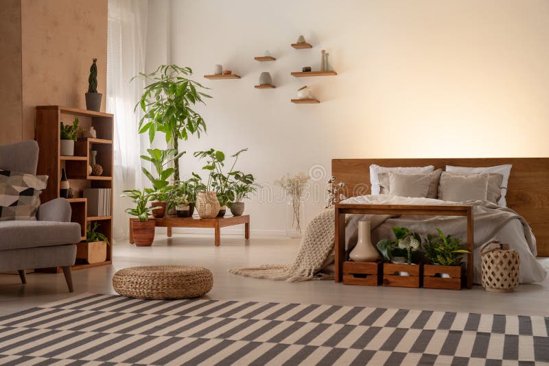 Interior morno do quarto com plantas, prateleiras, tapete listrado, pufe, b