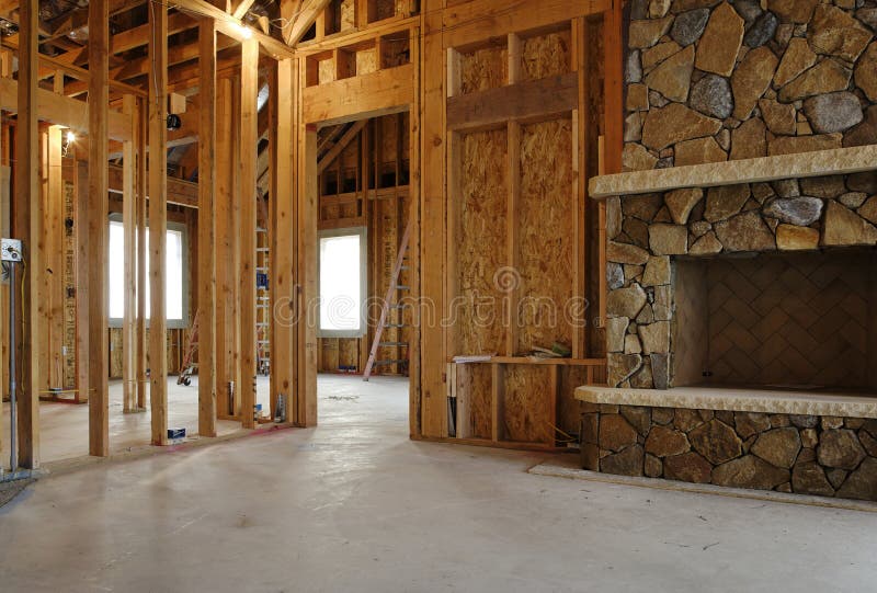 Interior view of a new home under construction. A stone fireplace has been installed. Horizontal shot. Interior view of a new home under construction. A stone fireplace has been installed. Horizontal shot.