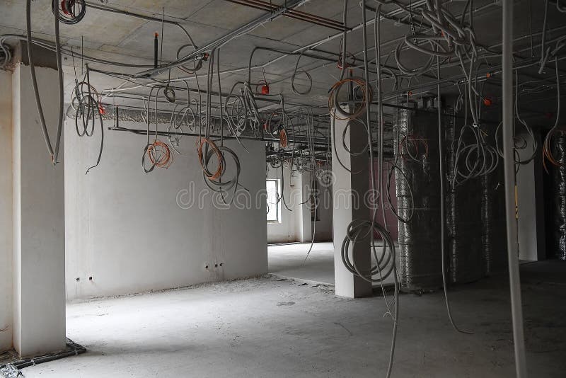 Interior of office or industrial premises under construction. Placement of electrical wires and cables