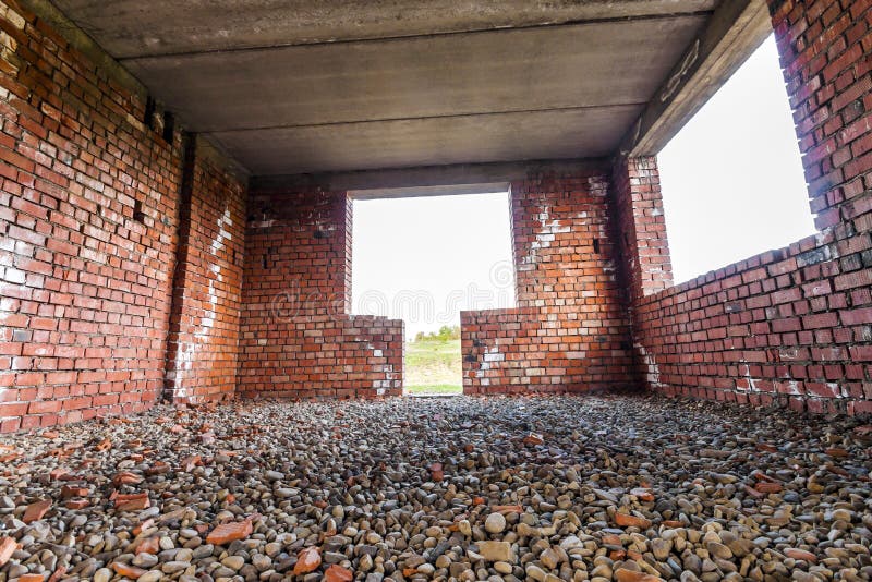 Interior of an old building under construction. Orange brick walls in a new house.