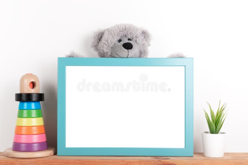 Interior poster mock up for nurcery, children`s room with vertical wooden frame, toys and teddy bear on white wall background